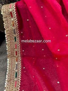 Sheer and lightweight hot pink organza dupatta with mutlicolor embroidery on gold border. Gold Sharara With Embroidered Border For Eid, Pink Organza Traditional Wear With Zari Work, Pink Saree With Sheer Dupatta For Festivals, Festive Pink Saree With Sheer Dupatta, Pink Sheer Dupatta Traditional Wear In Organza, Bollywood Style Gold Sharara With Embroidered Border, Festive Gold Sharara With Embroidered Border, Pink Bollywood Saree With Sheer Dupatta, Bollywood Style Pink Saree With Sheer Dupatta