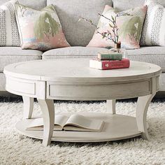 a white coffee table sitting on top of a rug