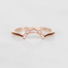 an image of a rose gold ring with diamonds on the top and bottom part,