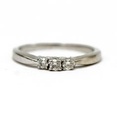 three stone diamond ring on white background