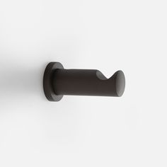 a black handle on a white wall