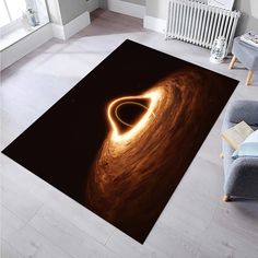 a large area rug with an image of a black hole in the center and a spiral design on it