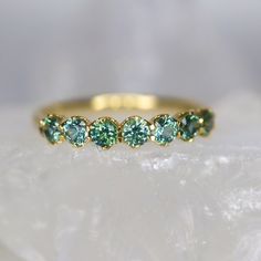 three stone ring with green and blue stones