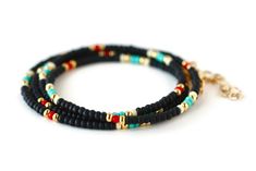 "Black, turquoise, red, white and gold beaded wrap style bracelet is 28\" long and will wrap around on average wrist (6.5-7\") four times. It comes with 1\" chain extender. It could be worn also as a necklace. Details: - Adjustable wrap style bracelet: 28\" long with 1\" chain extender, full length 29\" designed to fit 6.5-7\" wrists, - Listings include one bracelet - Bracelets may vary in exact pattern. Slight variations due to the individuality of each piece - This item should be kept away fro Hand Wrapped Black Jewelry For Beach, Hand Wrapped Black Beach Jewelry, Black Round Beads Jewelry For Beach, Black Spiritual Jewelry For The Beach, Spiritual Black Jewelry For The Beach, Spiritual Black Jewelry For Beach, Black Multi-strand Bohemian Bracelets, Bohemian Black Multi-strand Bracelets, Black Spacer Beads Jewelry For Festivals