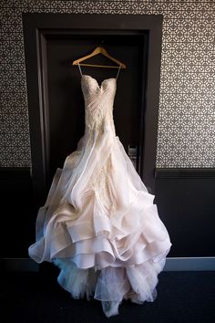 a dress hanging on a hanger in front of a door