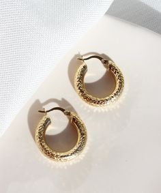 Textured Bold Hoop Earrings These stunning 14k gold hoop earrings with diamond cut pattern are prefect for everyday wear. They will add a precious touch to your daily outfits but also great for a night out look. They are definitely a must-have! Features: * These earrings are sold in pairs * They are made of patented 14k solid gold. * Size: 2,3 cm Packaging: You will get your jewelry in a beautiful pink Pharos Jewellery box. This box will protect your precious item during the shipping process. It Gold Small Hoop Earrings For Everyday Luxury, Everyday Luxury Gold Hoop Huggie Earrings, Diamond Cut Gold Plated Huggie Earrings, Diamond Cut Huggie Gold Plated Hoop Earrings, Luxury Small Hoop Pierced Earrings, Diamond Cut Huggie Hoop Earrings Gold Plated, Everyday Luxury Gold Diamond Cut Huggie Earrings, Everyday Luxury Gold Huggie Earrings With Diamond Cut, Luxury Small Hoop Earrings As Gift