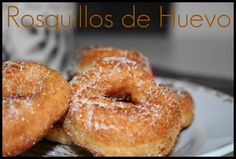 three sugared donuts on a plate with the words rosullos de huevo