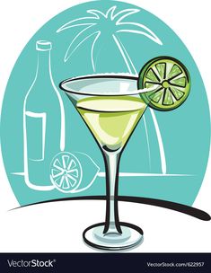 a martini glass with a lime slice on the rim and a bottle in the background