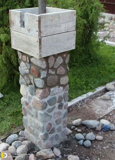 a fire hydrant sitting on top of a pile of rocks next to a sidewalk