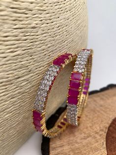 Ameriacan Diamond Ruby Red Bangles. It comes as a Pair (2 Bangles). Premium quality and craftmanship. Satisfaction Guaranteed. Please measure your size before ordering as we don't accept returns. Starting size we have is 2.4. We don't carry size 2.2. Red Stone Bangles, Ad Bangles, Stone Bangles, Ruby Bangles, Red Bangles, Indian Bangles, Bangles Indian, Stone Bangle, Pakistani Jewelry