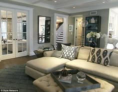 a living room filled with furniture and lots of windows