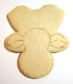 a wooden cutout of a teddy bear with leaves on it's back end