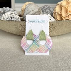 "These unique and fun spring plaid earrings are lightweight, featuring pearly white clay decorated with a pastel plaid design. Faux/vegan leather straps are threaded through the donut shaped clay pendants and used to attach them to earring wires. Clay is carefully hand mixed, decorated, molded, baked, sanded and sealed with high gloss resin before assembly. All creations are carefully crafted by hand, therefore no two items are identical. Slight variations in plaid patterns are to be expected. E Trendy Circle Earrings For Spring, Spring Casual Hypoallergenic Jewelry, Casual Hypoallergenic Jewelry For Spring, Casual Hypoallergenic Spring Jewelry, Handmade Pastel Jewelry For Spring, Pastel Jewelry For Spring Gift, Casual Everyday Spring Jewelry, Casual Dangle Jewelry For Spring, Everyday Green Jewelry For Spring