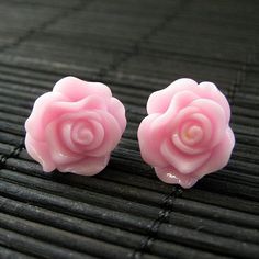 Silver tone post earrings (no nickel) are combined with pretty handmade resin roses in a soft shade of blush pink. The pair also comes with a matching set of silver tone earring backs.Size: 14mm rosesThese earrings are available in a variety of colors! http://etsy.me/1rv1YFVThey are also available as dangle earrings!Bronze - https://www.etsy.com/stumblingonsainthood/listing/106361809Silver - https://www.etsy.com/stumblingonsainthood/listing/113486696If you would like to order a larger quantity t Pink Rose Flower Earrings For Gift, Pink Flower Earrings With Rose Design, Pink Rose Earrings, Earrings Flower, Flower Jewelry, Earrings Stud, Rose Earrings, Flower Jewellery, Handmade Design