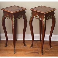 two wooden tables sitting next to each other on top of a hard wood flooring