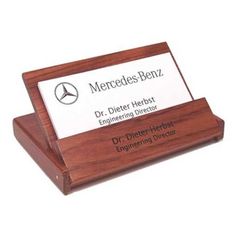 a wooden business card holder with a mercedes benz logo on the front and bottom side