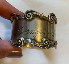 "Very pretty Victorian napkin ring. It is sterling made by National Silver Co. it is engraved Evangeline M Anderson. It is 1.25\" wide.  Condition is very good." Collectible Antique Silver Engraved Ring, Antique Silver Engraved Ring Collectible, Vintage Silver Engraved Ring For Commemoration, Vintage Silver Engraved Wide Band Ring, Elegant Silver Engraved Ring For Commemoration, Antique Silver Engraved Ring For Commemoration, Antique Silver Engraved Ring With Hallmarks, 1928 Jewelry, Coral Bracelet