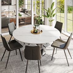 a dining room table with chairs and a vase on top of it in front of large windows