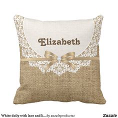 a decorative pillow with the name elizabeth in gold ribbon and lace on burlock