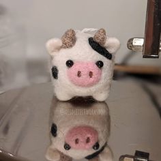 a small stuffed cow sitting on top of a table