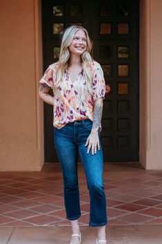 Elevate your wardrobe with this vibrant, patterned top. Featuring a playful mix of warm hues, this blouse is perfect for adding a pop of color to any outfit. The relaxed fit and lightweight fabric ensure comfort, while the gathered neckline and short sleeves offer a flattering, feminine touch. Pair it with your favorite jeans for a chic, effortless look. Ideal for casual outings or a stylish day at the office. Casual Abstract Print Blouse For Fall, Casual Blouse With Abstract Print For Fall, Casual Abstract Print Tops For Fall, Casual Blouse With Colorful Pattern For Fall, Casual Colorful Pattern Tops For Fall, Casual Tops With Vibrant Print For Fall, Multicolor Print Top For Fall Day Out, Casual Colorful Patterned Relaxed Fit Top, Multicolor Print Top For Day Out In Fall