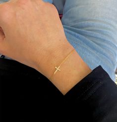 Our Esther Dainty Diamond Cross Bracelet is a glimmering beacon of faith. Stylish and elegant, this bracelet embodies the beauty of His grace. Perfect to shine on its own but sophisticated enough to add to a stack. The intentional delicacy of this design makes for the heartfelt gift of a child's first piece of fine jewelry or an adult's everyday dainty wear. Metal: 18k White Gold / 18k Yellow Gold / 18k Rose Gold Round Brilliant Cut Natural Diamonds: Approx. 0.10 ctw G Color and SI1-2 Clarity Diamonds Length: 7 inches at the longest. ﻿Adjustable sliding bead to provide options for smaller wrist size. Closure: Lobster clasp Measurements: Approx. 11.7mm length x 5.9mm width Looking for a different size? Please email us. Diamond Cut Sterling Silver Bracelet Gift, Sterling Silver Diamond Cut Bracelet Gift, Luxury Yellow Gold Rosary Bracelet Gift, Elegant Sterling Silver Cross Rosary Bracelet, Fine Jewelry Diamond Cut Bracelets For Gift, Diamond Cut Bracelet Jewelry Gift, Fine Jewelry Diamond Cut Bracelet As A Gift, Diamond Cut Bracelets As Fine Jewelry Gifts, Diamond Cut Bracelet Jewelry As A Gift