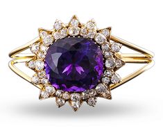 Weighing approximately 50 carats, the cushion-cut amethyst at the center of this bangle bracelet exhibits the deep, evenly distributed purple color found in only the finest examples. Creating a starburst motif around the amethyst are approximately 5 carats of diamonds. 18K yellow gold. Luxury Elegant Amethyst Bangle, Luxury Purple Brilliant Cut Jewelry, Luxury Cushion Cut Purple Jewelry, Golconda Diamond, Diamond Bangle Bracelet, Amethyst And Diamond Ring, Amethyst Healing, Jewelry For Sale, Diamond Bangles Bracelet