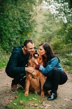 a man and woman are kissing their dog