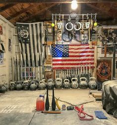 a garage with an american flag hanging on the wall and various tools in front of it