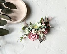 This stunning hair comb is made using handmade paper flowers and artificial foliage for that perfect final touch to your big day. It comes with all the beauty of real flowers but will never wilt and so will be a forever keepsake.  It easily slides into the hair and adds a beautiful finish to any style. It can be used as an alternative to a veil or it can sit elegantly on top so you won't have to make a choice between them!  This bespoke piece is perfect for either the bride, bridesmaid or mother or the bride and/or groom. Each hair piece is handmade in my Madgicks Studio and it will be beautifully packaged for that extra special touch.  It is perfect for a rustic and woodland wedding but would equally look lovely for a vintage and classic bride. It measures approximately 12cm wide and 8cm Sage Green Hair, Sit Elegantly, Flower Hair Clips Wedding, Sage Green Flowers, Floral Hair Pieces, Sage Green Floral, Sage Wedding, Floral Hair Combs, Artificial Foliage