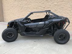 the can - am commander is parked in front of a building