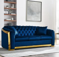 a blue couch with gold trim in a living room