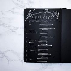 an open notebook with the words sleep log written on it