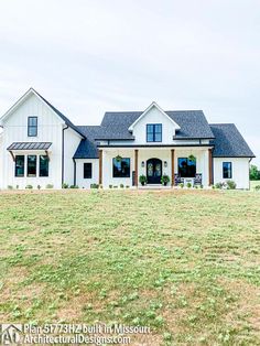 a large white house sitting on top of a lush green field