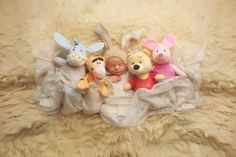 a group of stuffed animals sitting on top of a blanket