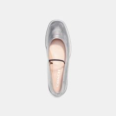 A modern take on a timeless style our go-with-everything Emilia Mary Jane is a super-lightweight design crafted of supple metallic leather. Finished with a sleek elastic band the slip-on flat features a cushiony foam footbed for all-day comfort and a rubber sole for great traction. | Coach Emilia Mary Jane In Silver Metallic - Women's Size 7 Modern Slip-on Ballet Flats For Summer, Silver Slip-on Flats With Removable Insole, Modern Slip-on Flats For Spring, Sleek Flats With Branded Insole, Modern Slip-on Ballet Flats For Fall, Sleek Slip-on Ballet Flats For Spring, Chic Silver Slip-on Flats, Silver Leather Flats For Spring, Trendy Leather Flats For Evening