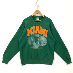 Vintage Miami Hurricanes Sweatshirt Green Long Sleeve Fan Apparel Top, Oversized Long Sleeve Throwback Tops, Oversized Throwback Fall Tops, Oversized Throwback Top For Fall, Green Crew Neck Retro Top, Throwback Green Tops For College, Retro Green Crew Sweatshirt, Green Retro Crew Sweatshirt, Vintage Green College Sweatshirt