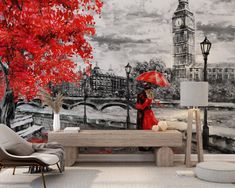 a woman with an umbrella is sitting on a bench in front of a wall mural