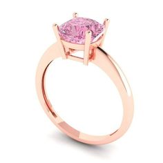 a pink diamond ring on a white background with the center stone set in 18k rose gold