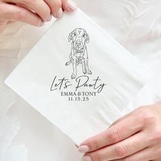 a person holding a napkin with a dog on it