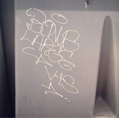 graffiti written on the side of a urinal