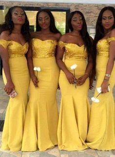 three women in yellow dresses standing next to each other