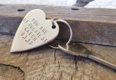 two heart shaped key chains with words on them