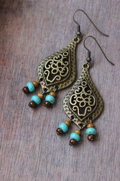 "These unique boho earrings was made of big drop shape antique brass charms, tiny czech glass \"picasso\" style blue,brown beads and antiqie brass earring hooks. Earring hooks are from nickel free and lead free metal. A wonderful jewelry for you or an unique gift for someone speacial! *The total lenght of earrings is about 67 mm including earring hooks. Other earrings of my shop you can see here: https://www.etsy.com/shop/NaTavelli?section_id=13757927 Thanks for visit." Vintage Dangle Beaded Earrings For Festival, Bohemian Teardrop Jewelry With Dangling Beads, Brass Chandelier Earrings For Festivals, Bohemian Bronze Chandelier Earrings For Pierced Ears, Brass Chandelier Drop Earrings For Festival, Bohemian Bronze Chandelier Earrings, Bronze Bohemian Chandelier Earrings, Bohemian Bronze Earrings With Dangling Beads, Vintage Beaded Drop Earrings For Festivals