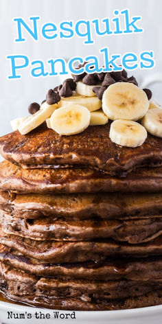 a stack of pancakes topped with bananas and chocolate chips