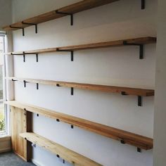 some shelves are lined up against the wall