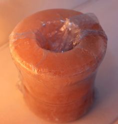 a plastic wrapped doughnut sitting on top of a counter