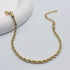 Crafted with meticulous attention to detail, this bracelet features a mesmerizing twisted chain design, adding a touch of glamour to any outfit. Whether you're dressing up for a special occasion or adding a chic accent to your everyday look, our bracelet is the perfect choice. Available in silver and gold Elegant Bracelets With Rope Chain And Link Shape, Elegant Bracelets With Rope Chain Link, Elegant Bracelets With Link Rope Chain, Elegant Rope Chain Link Bracelets, Rope Chain Bracelet As A Gift, Elegant Rope Chain Link Bracelet, Trendy Chain Bracelet With Lobster Clasp For Party, Trendy Metal Jewelry With Rope Chain, Elegant Braided Bracelet With Adjustable Chain