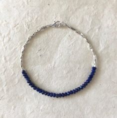 Lapis lazuli, Karen Hill Tribe Thai silver beaded stacking bracelet 7 inches is average size Lapis Lazuli metaphysical properties: Inner truth, inner power, love, purification, intuition, self-confidence, manifestation, friendship Can be custom made with any gemstone Please note Gemstones are works of nature, therefore, can have differences in color and may have inclusions. Because of this, your piece may vary slightly from what is pictured. Thai Silver or Karen Hill Tribe Silver are all complet Adjustable Faceted Sapphire Bracelets, Bohemian Blue Rondelle Bracelets, Adjustable Faceted Sapphire Bracelet, Adjustable Lapis Lazuli Beaded Bracelet With Faceted Beads, Flexible Blue Beaded Bracelets, Blue Faceted Beads Bangle Jewelry, Blue Faceted Bead Bangle, Blue Bangle With Faceted Beads, Blue Tiny Beads Bangle Jewelry