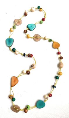 Multi-Color Tagua Long Necklace Ecuadorean Tagua Jewelry - Eco Friendly Color: Multi-Color Part Number: TAG541 Item Weight: .65oz Product Length: 35 inches long About Tagua This Product is handcrafted from a palm tree nut native to the lush tropical rainforests of Ecuador. Also referred to as the Ecuadorean Ivory Palm, the Tagua tree produces several bushels of seed pods a year with up to 100 Tagua nuts per pod. These nuts are then harvested, dried, and crafted into a wide range of products from Ivory Necklace, Tagua Jewelry, Tagua Nuts, Seed Pods, Necklace Long, Ecuador, Palm Tree, Long Necklace, Nuts